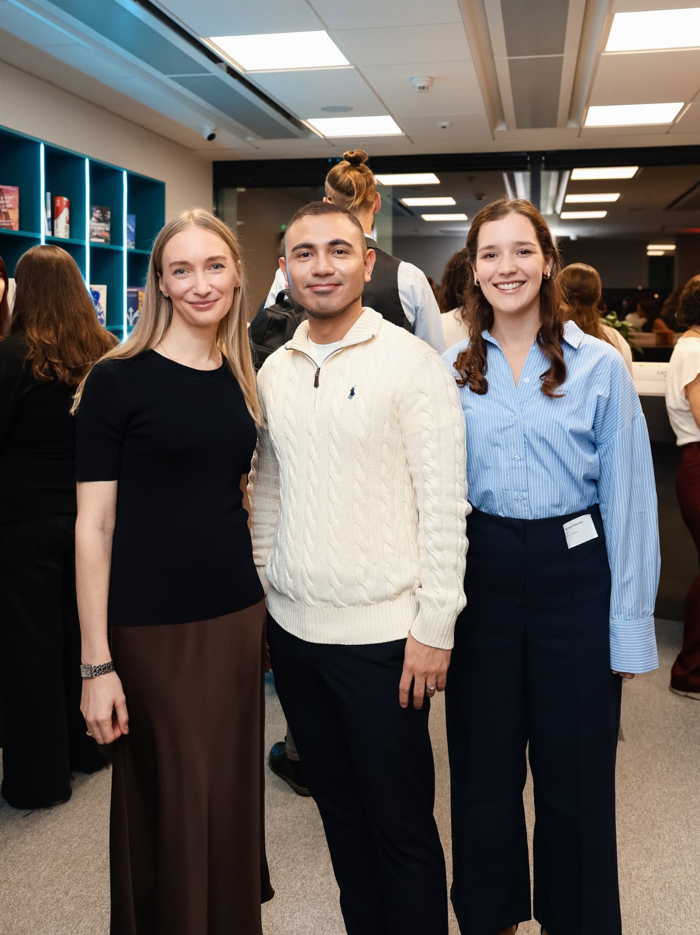 Three guests smiling during networking